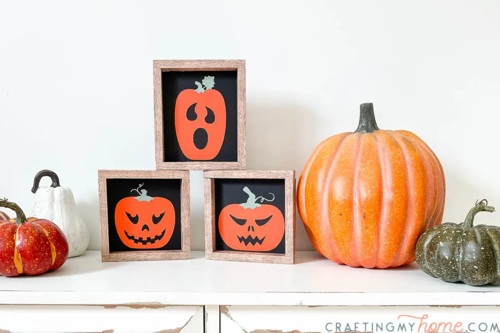 Halloween vignette created with jack-o-lantern signs and pumpkins. 