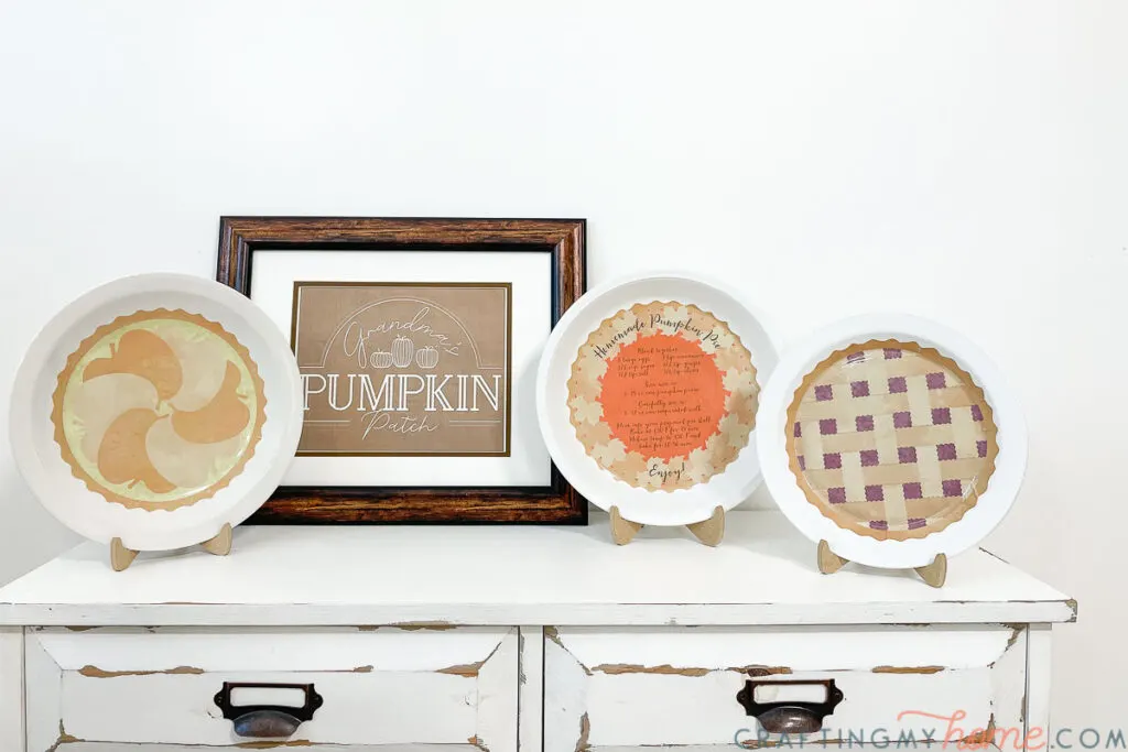 Three DIY decorative plates with images of pies on the back.