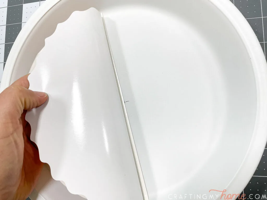 Lining up the center marks to lay down the vinyl in the base of the pie plate. 