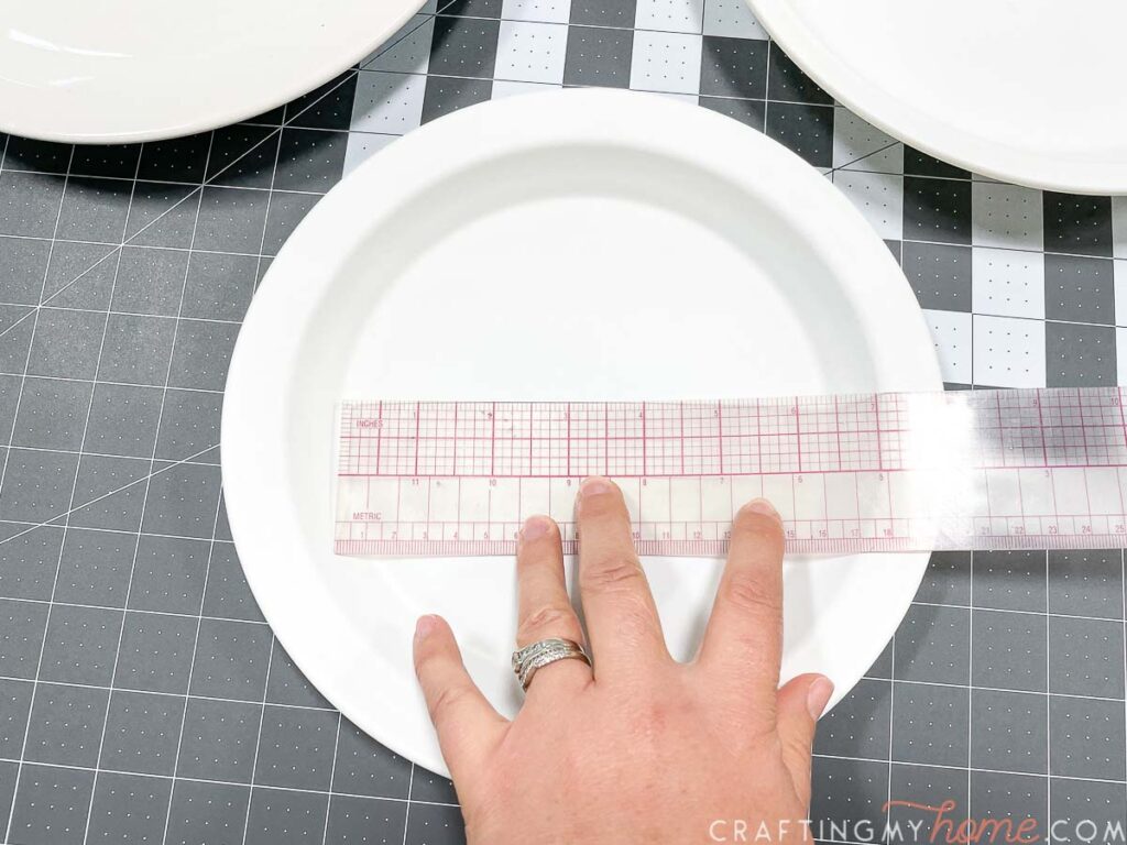 Measuring the size of the center of the pie plate. 
