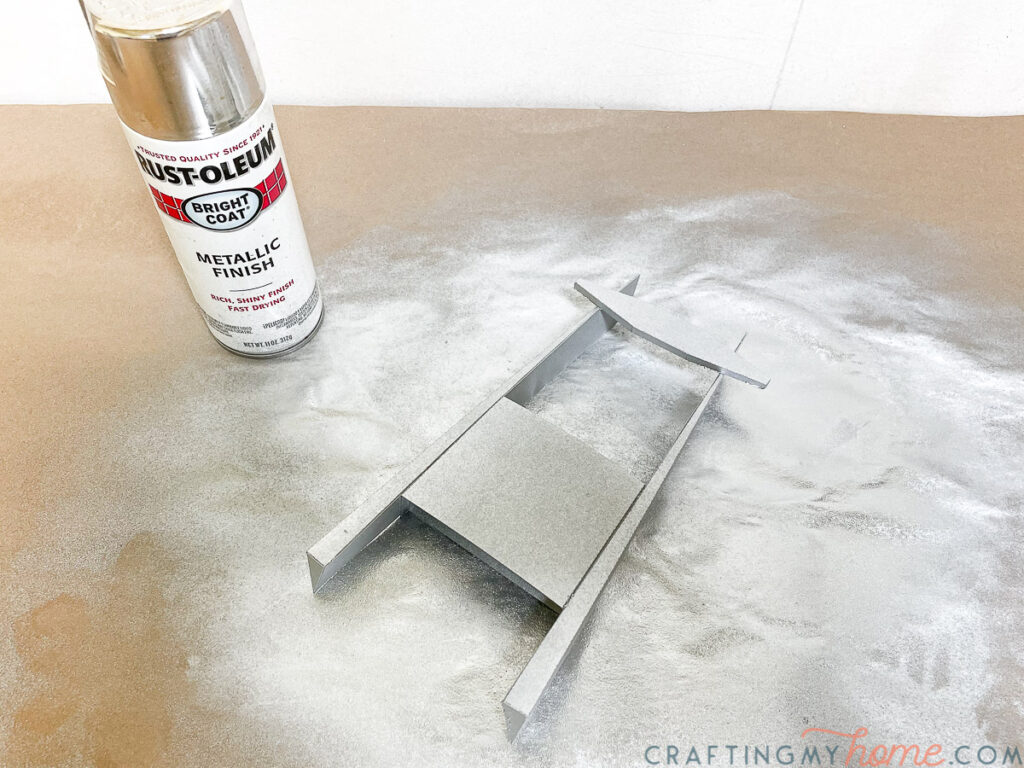Spray painting the base and blades with a metallic spray paint.
