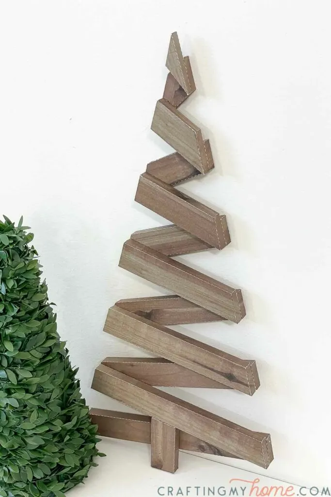 Faux wood Christmas tree made out of paper. 