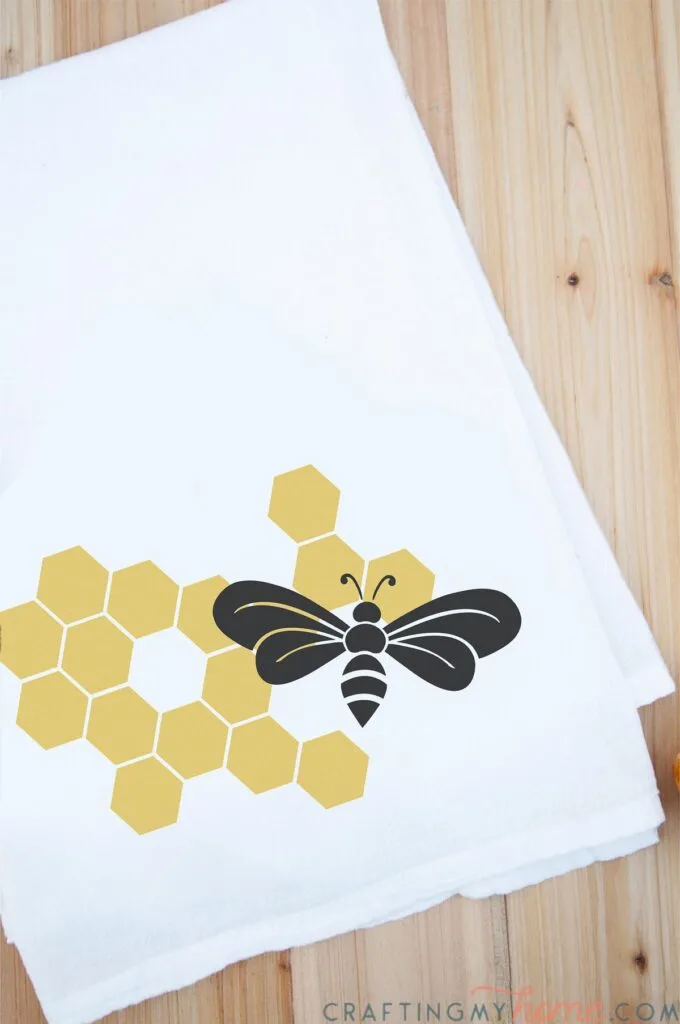 Honey bee SVG design on the front of a tea towel.