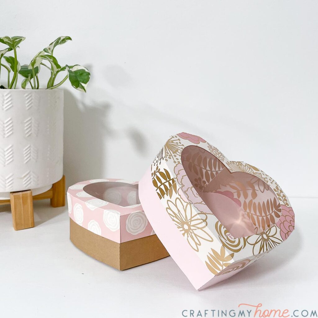 Two DIY heart boxes with floral patterned lids and clear openings for chocolates or gifts.