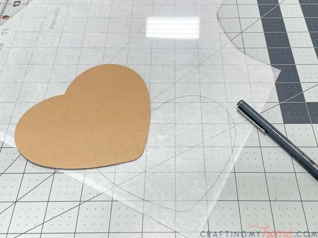 Heart piece cut out of cardstock traced onto a piece of thin plastic.