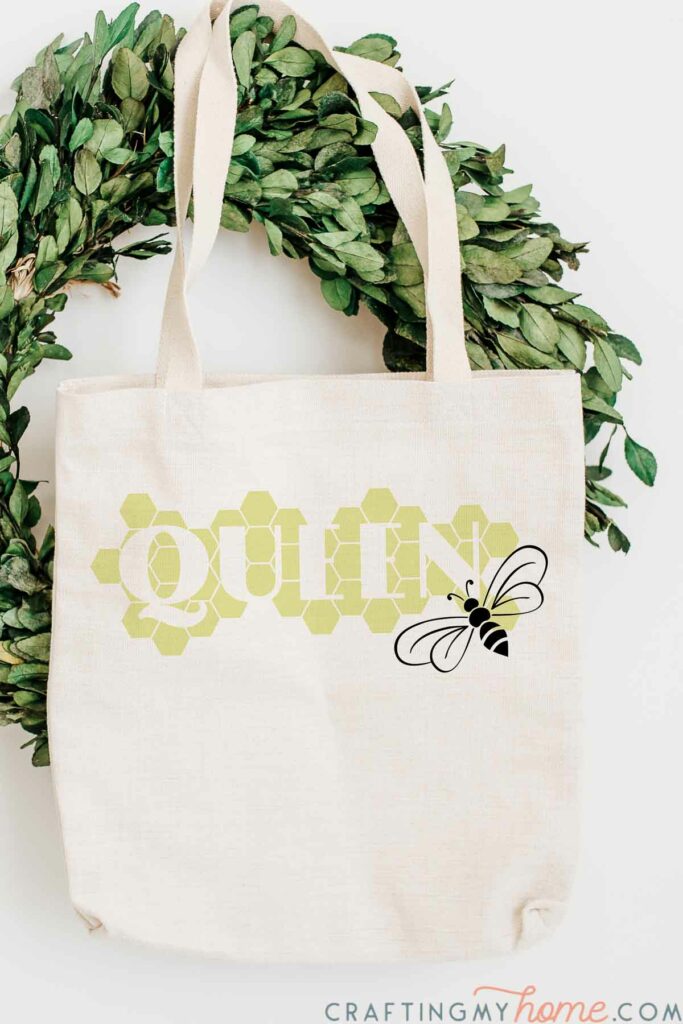 Canvas bag with Queen Bee SVG on the front in a honeycomb pattern.