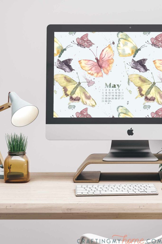 May digital background with watercolor butterflies on a desktop computer.