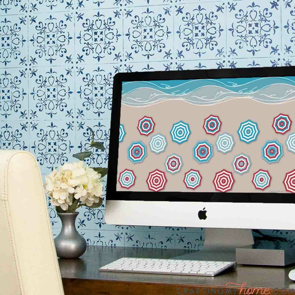 Desktop computer with beach umbrella design digital background on the screen. 