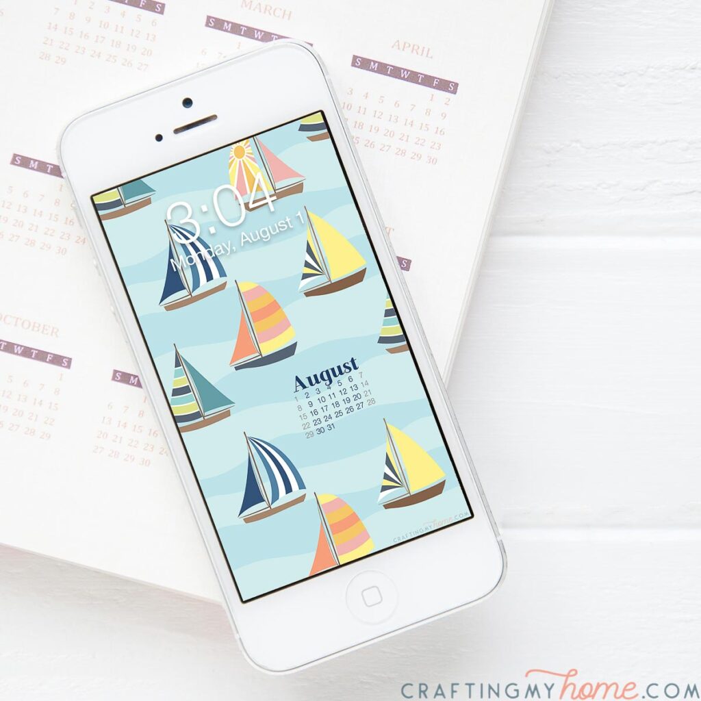 Free digital background for August with a current month's calendar on a smartphone screen on a notebook. 