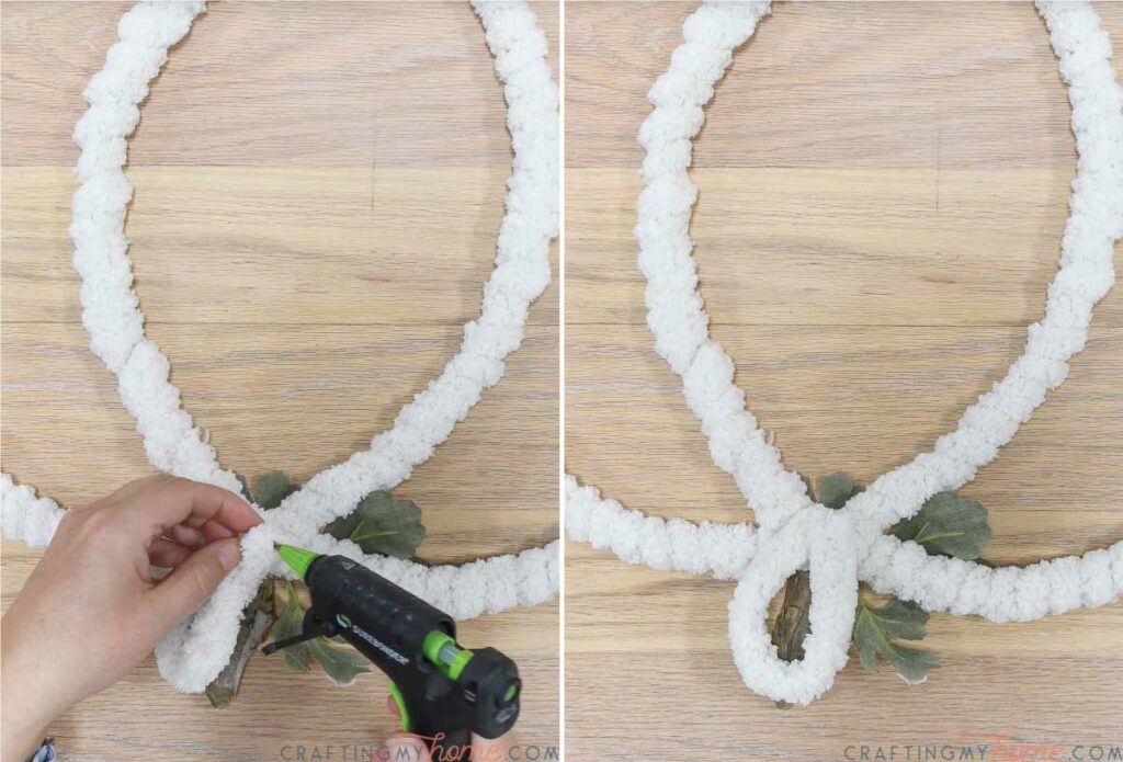 Creating a loop to hang the wreath with a piece of the cream yarn. 
