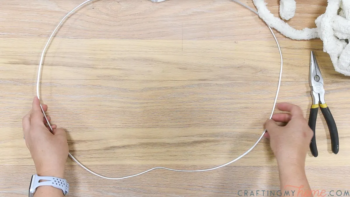 Bending craft wire into pumpkin shape. 